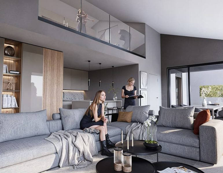 Interno moderno di una casa con soggiorno a pianta aperta, due donne sono sedute sul divano e una terza persona legge in cucina.