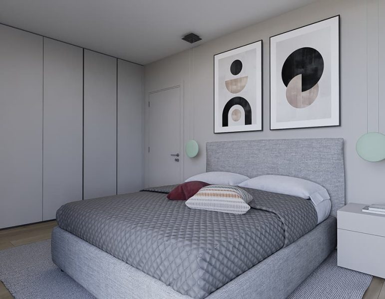 Camera da letto moderna con letto imbottito grigio, testiera imbottita, comodini bianchi, armadiature scorrevoli, decorazioni circolari alle pareti e quadri astratti sopra il letto.