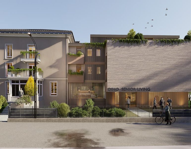 Edificio contemporaneo di residenze senior, facciata mista in mattoni e cemento, ingresso con persone, giardino frontale e biciclette sul marciapiede.